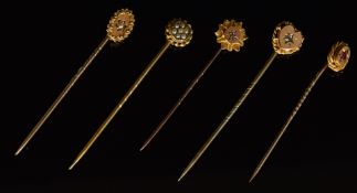 Three 9ct gold stick pins set with paste, pearls and a diamond (2.7g) and two 15ct gold stick pins