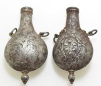 Two 18th / 19thC steel perfume or  powder flasks with engraved and repoussé figural decoration, both
