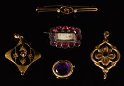 Victorian mourning brooch set with foiled garnets, two Edwardian 9ct gold pendants, amethyst