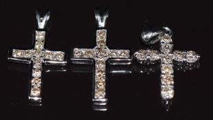 Three 18k white gold pendants in the form of crosses set with diamonds, 3.2g