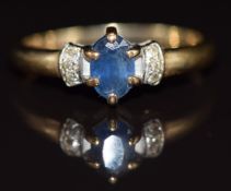 A 9ct gold ring set with an oval cut sapphire and diamonds, 1.9g, size M