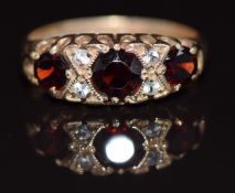 A 9ct gold ring set with garnets and white sapphires, 2g, size G