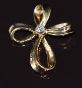 An 18k gold pendant in the form of a stylised cross set with a diamond of approximately 0.13ct, 3.8g