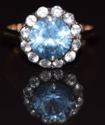 A 9ct gold ring set with a topaz surrounded by white sapphires, 3.5g, size M