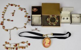 A collection of costume jewellery including yellow metal ring set with an opal, coral, tiger's