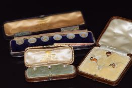 A set of three 18ct gold studs set with pearls (3.8g), two 18ct gold studs (2.4g), a 15ct gold