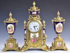 French brass and porcelain mantel clock garniture with 'Imperial' to the face and decorated with