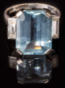 An 18ct white gold ring set with an emerald cut aquamarine of approximately 8.3ct and two baguette