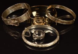 Three silver bangles, silver buckle ring (Birmingham 1889) and a rolled gold bangle