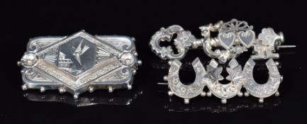 Three silver brooches comprising one in the form of three horseshoes (Birmingham 1901), one in the