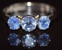 An 18ct white gold ring set with three sapphires, 2.9g, size M