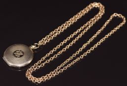 A c1920 9ct gold engine turned locket on 9ct gold chain, 22.4g