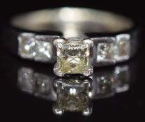 A 14ct gold ring set with a princess cut diamond of approximately 0.6ct and four further princess