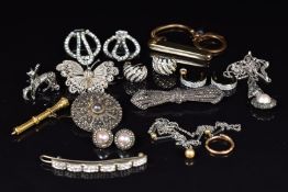 A silver necklace set with a pearl surrounded by marcasite, a pair of silver earrings set with a