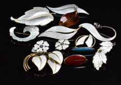 A collection of enamel set jewellery comprising eight silver Norwegian brooches, a Danish silver