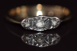 An 18ct gold ring set with three rose cut diamonds in a platinum setting, 1.4g, size M