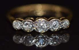 An 18ct gold ring set with five diamonds in a platinum setting, size N, 2.4g