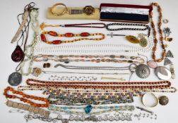 A collection of costume jewellery including amber necklace, filigree bracelets, silver ring,