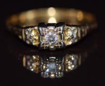 An 18ct gold ring set with a round cut diamond in a floral setting, 1.6g, size Q