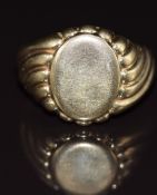 A 9ct gold signet ring with ridged shoulder decoration, 8.9g, size M