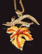 A 9ct gold pendant in the form of a maple leaf set with enamel, on 9ct gold chain, 5.9g
