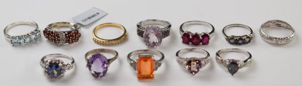 A 9k white gold ring (0.7g) and eleven silver rings including ruby, amethyst, topaz, etc