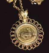A yellow metal pendant set with a 1982 1/10 Krugerrand, on 9ct gold chain, 7.5g