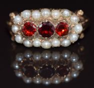 A 9ct gold ring set with three garnets surrounded by pearls, 4.9g, size P/Q