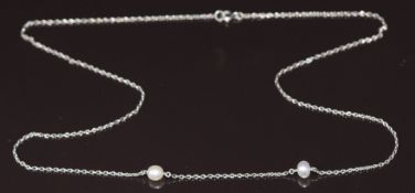 A c1920 9ct white gold necklace set with two pearls, 3.3g