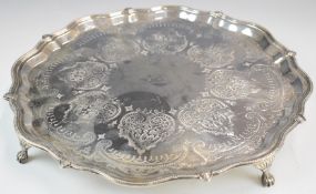 Edward VII hallmarked silver salver with shaped edge, engraved decoration and raised on four feet,