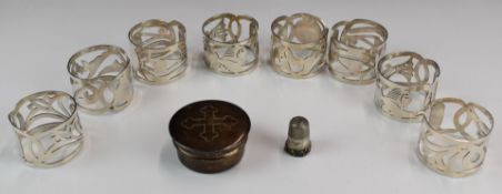 Eight Egyptian silver napkin rings together with a hallmarked silver communion pot, London 1930,