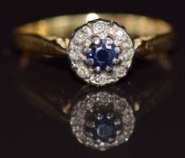 An 18ct gold ring set with a sapphire surrounded by diamonds, 3g, size O