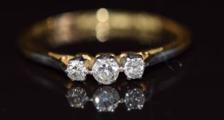 An 18ct gold ring set with three diamonds in a platinum setting, 1.6g, size M