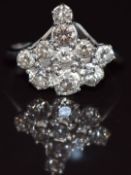 An 18ct white gold ring set with a cluster of old cut diamonds, the largest approximately 0.28ct,