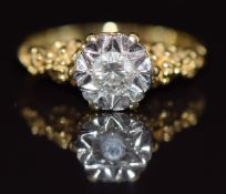 An 18ct gold ring set with a diamond of approximately 0.2ct in an illusion setting, with floral