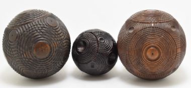 Sewing, needlework and embroidery interest three 19thC carved wood puzzle balls / thimble