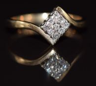 A 9ct gold ring set with diamonds in a square setting, 1.8g, size J