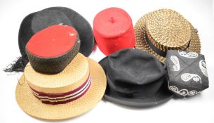 A collection of vintage hats including two straw boaters, Spanish felt hats, fez examples etc