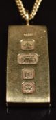 A 9ct gold ingot with feature hallmarks, on 9ct gold chain (44cm long), 37.2g
