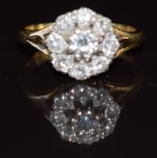 An 18ct gold ring set with diamonds in a cluster, the centre diamond approximately 0.2ct, 3.9g, size