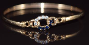 A 9ct gold bangle set with sapphires and cubic zirconia, 6.7g