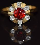 An 18ct gold ring set with garnet surrounded by diamonds, 4.3g, size M/N