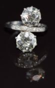 Art Deco platinum ring set with two transitional cut diamonds of approximately 2.1ct and 2ct and