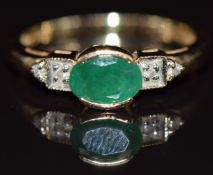 A 14k gold ring set with an oval cut emerald and diamonds, 2.9g, size M