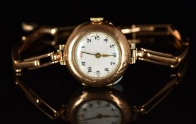 Unnamed 9ct gold ladies wristwatch with gold hands, black Arabic numerals, white dial and quartz