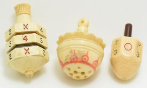 Three carved bone and other spinning tops or teetotums, including one doubling as a vinaigrette