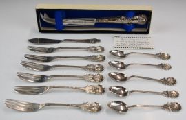 White metal cutlery comprising cake forks and teaspoons with floral finials, together with a