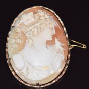 A 9ct gold brooch set with a cameo depicting a young woman with a swallow