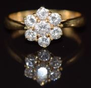An 18ct gold ring set with diamonds in a cluster, 2g, size F