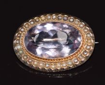 A 9ct rose gold brooch set with an oval cut amethyst surrounded by seed pearls, 6.1g 3x2.2cm
